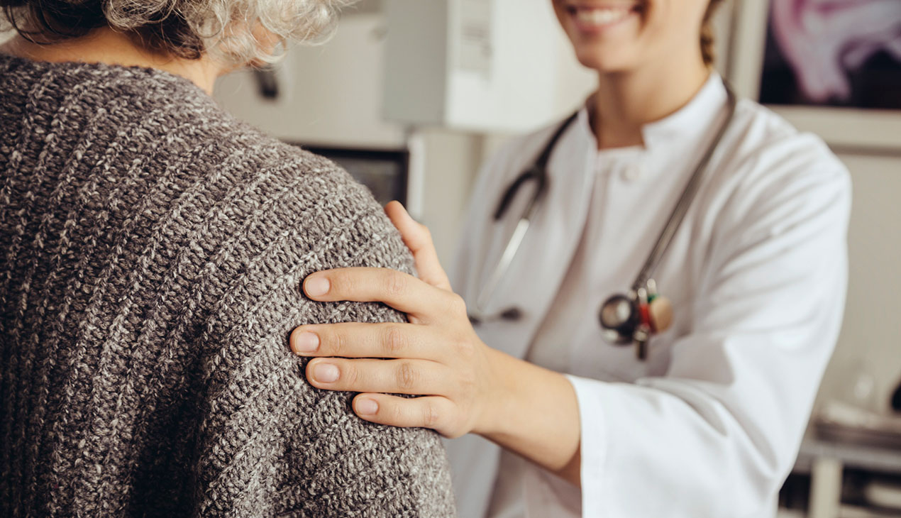 Physician with a hand on patient's shoulder