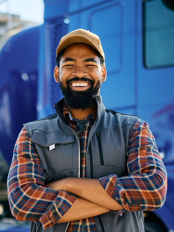 Semi truck driver smiling outside