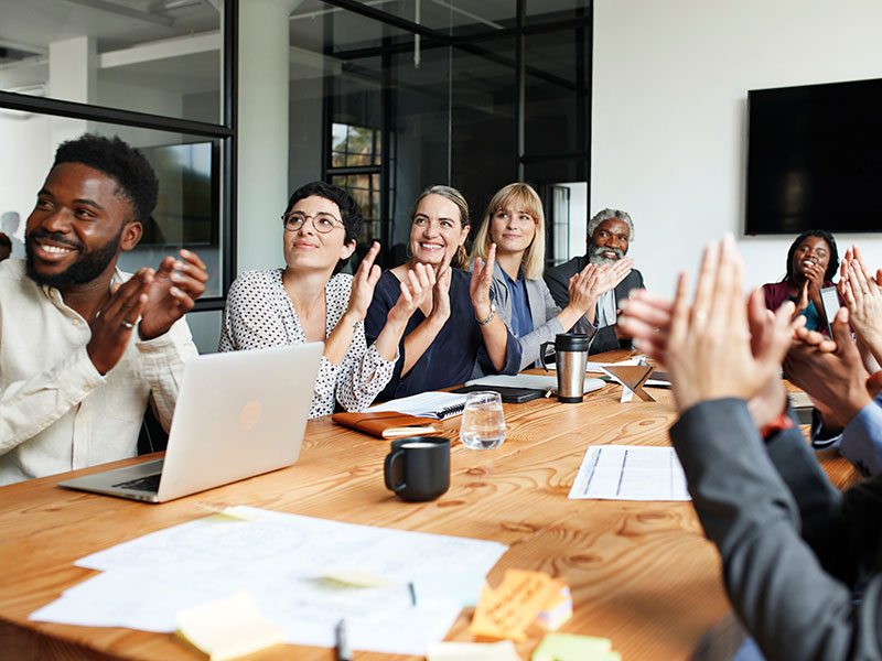 People clapping in a work meeting