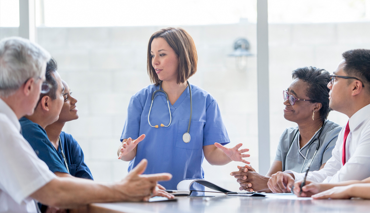 physicians sitting at a table and talking