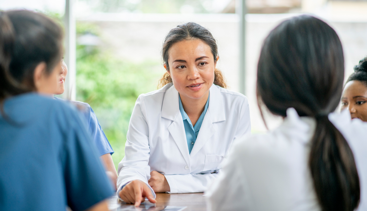 physicians sitting at table and talking