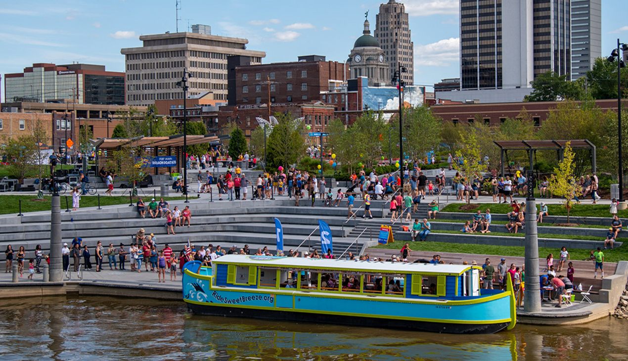 Riverfront park with large boat in water