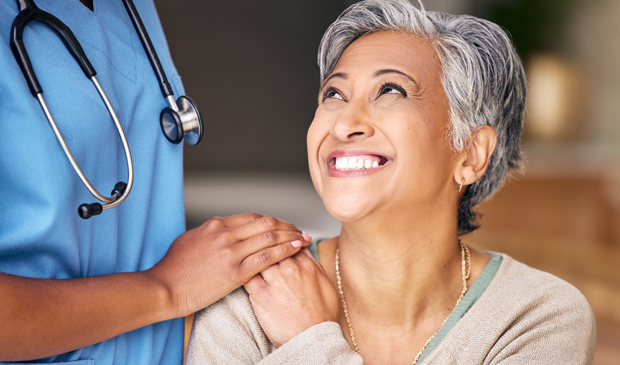 Female patient smiling up at provider