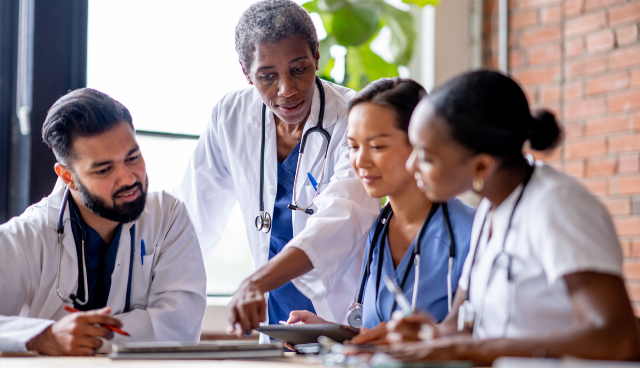 residents and physician looking at paper