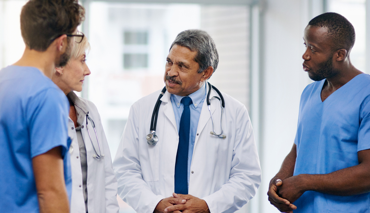 Doctor talking to other healthcare workers