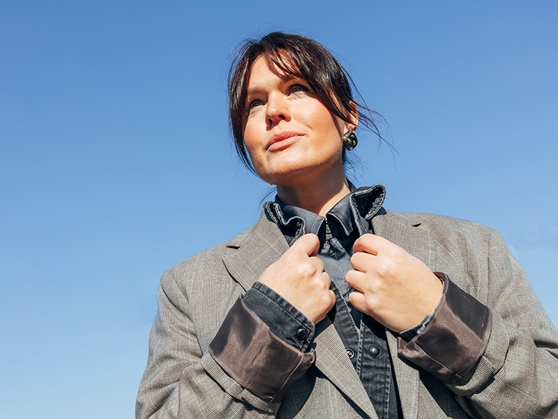 Woman smiling and holding jacket