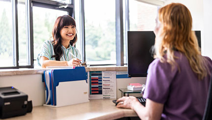 woman checking in at front desk