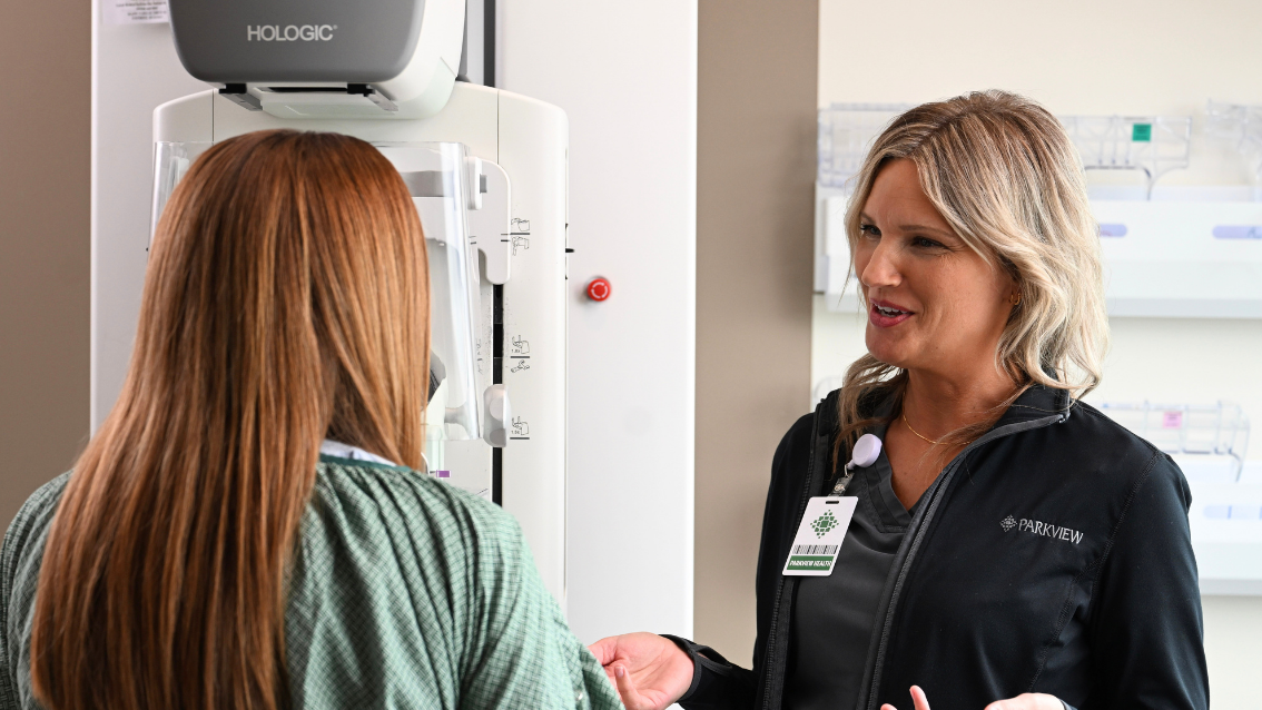 Nurse talking with patient about cancer screenings