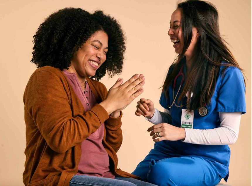patient and nurse laughing together