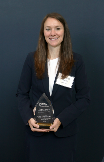 Brooke Randol, RN holding Caregiver of the Year award