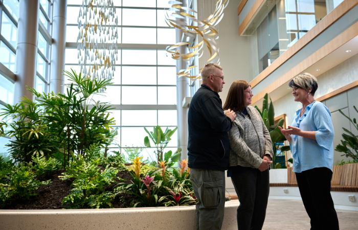 PFCI person talking to patients in the PFCI building