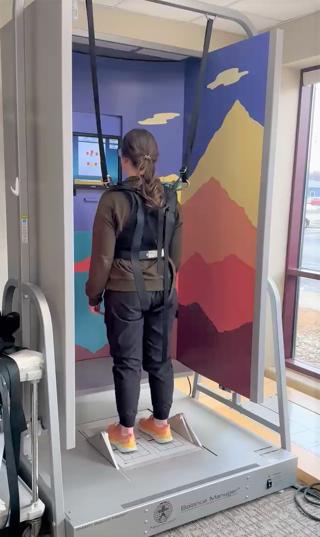 Patient on balance trainer machine