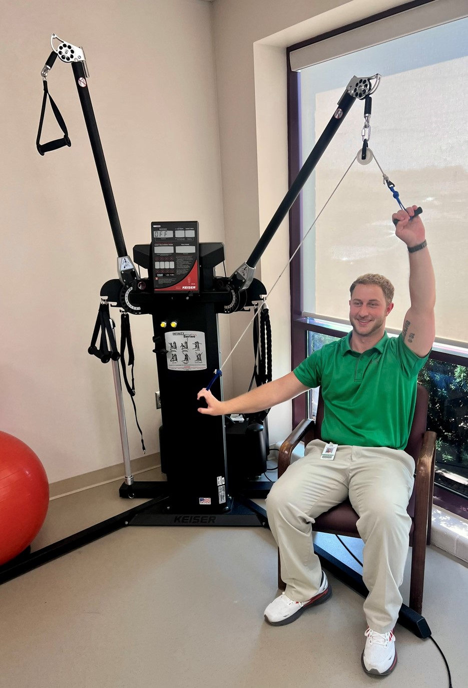 Trainer demonstrating cable machine