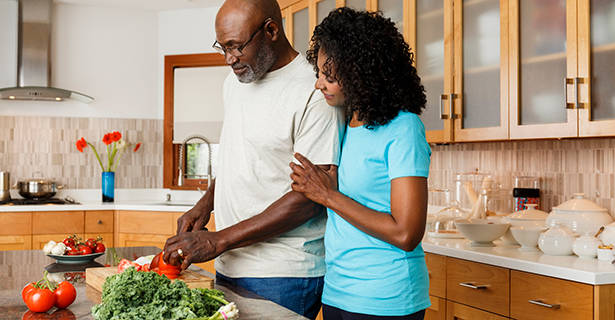 older couple chopping vegetables together