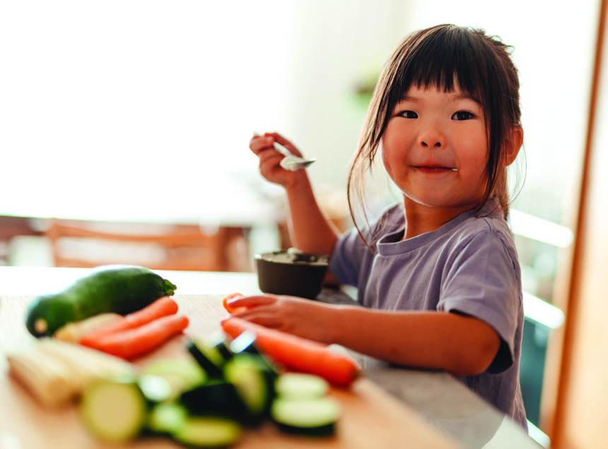 Child eating vegetables at the table