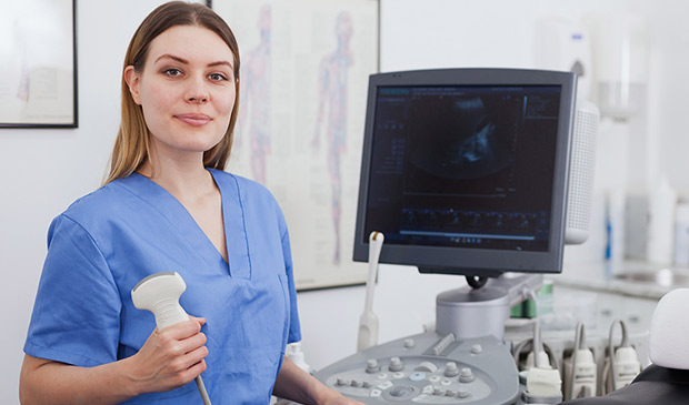 Technician next to ultrasound machine