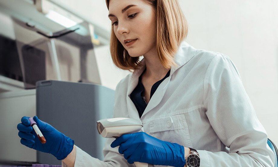 Lab tech checking in a vial of blood