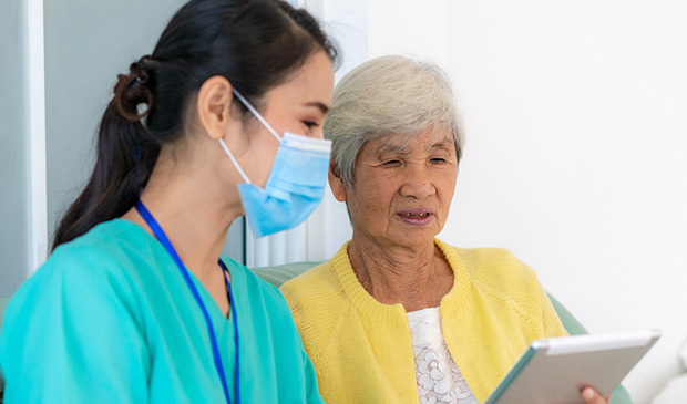 A medical assistant reviews notes with a patient
