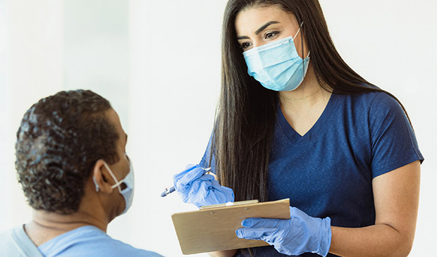 Medical assistant interviewing patient