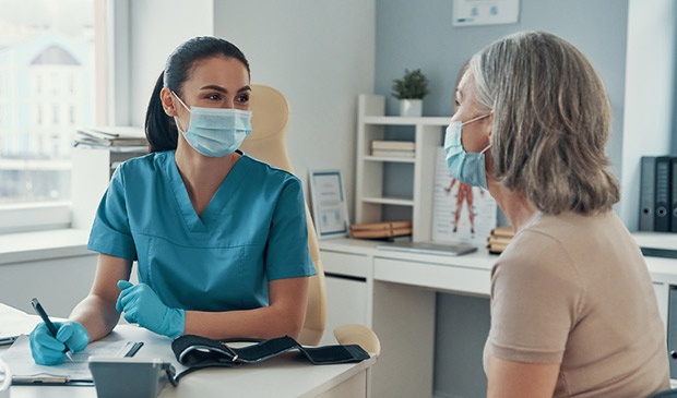 Medical assistant adivsing a patient