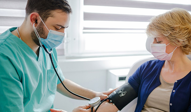 Medical assistant taking a patient's blood pressure