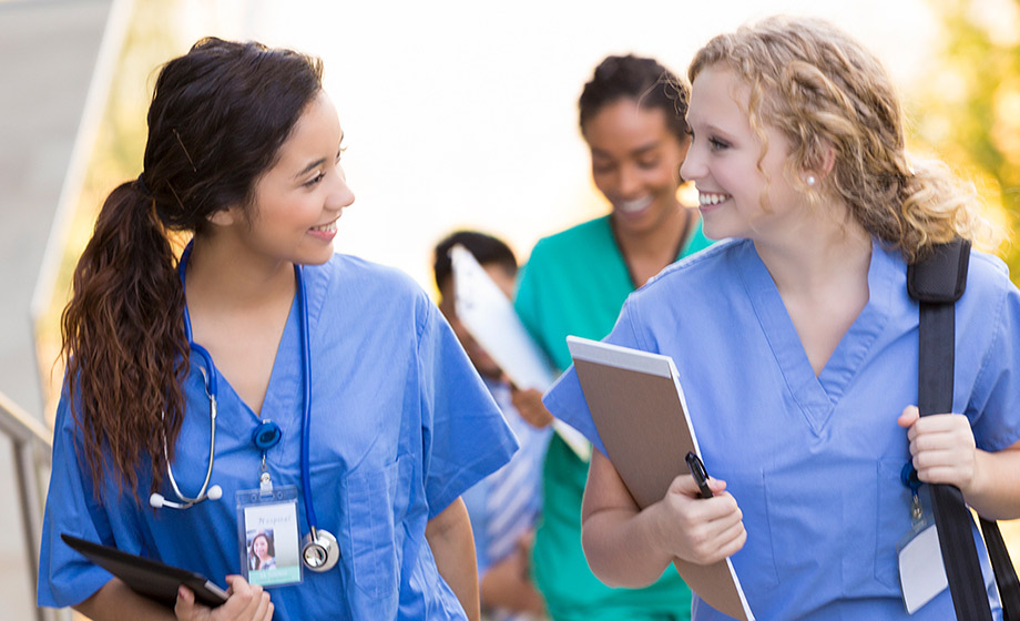 Two nurses talking on the stairs