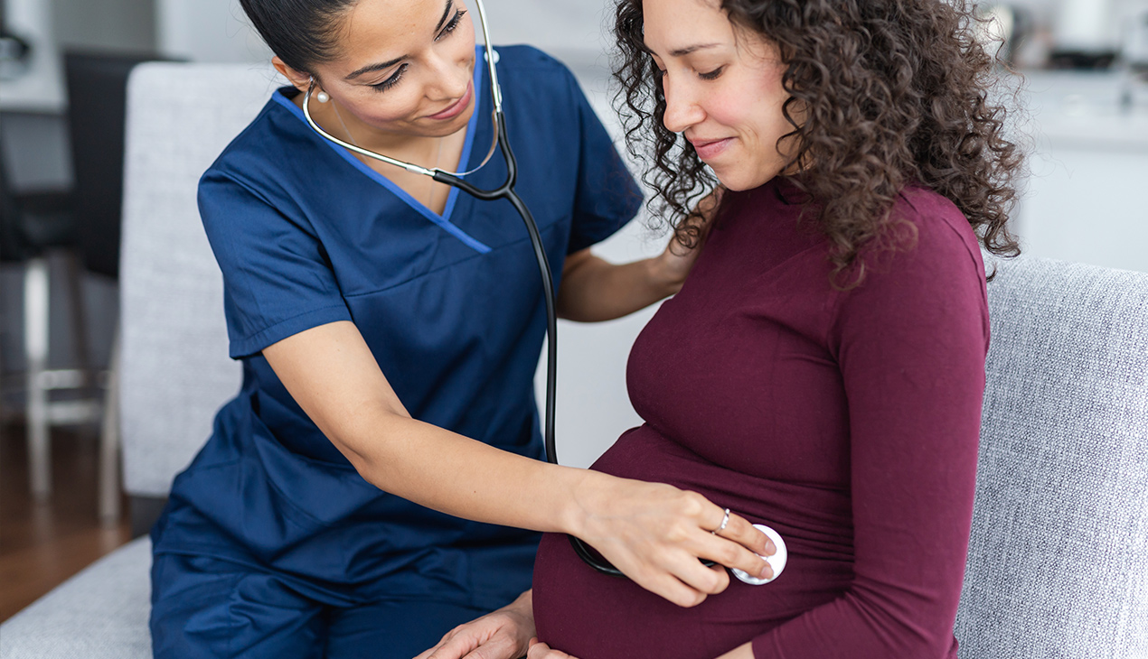 Healthcare worker taking fetal heartbeat