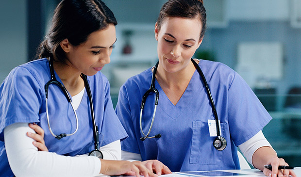 Two nurses reviewing a file
