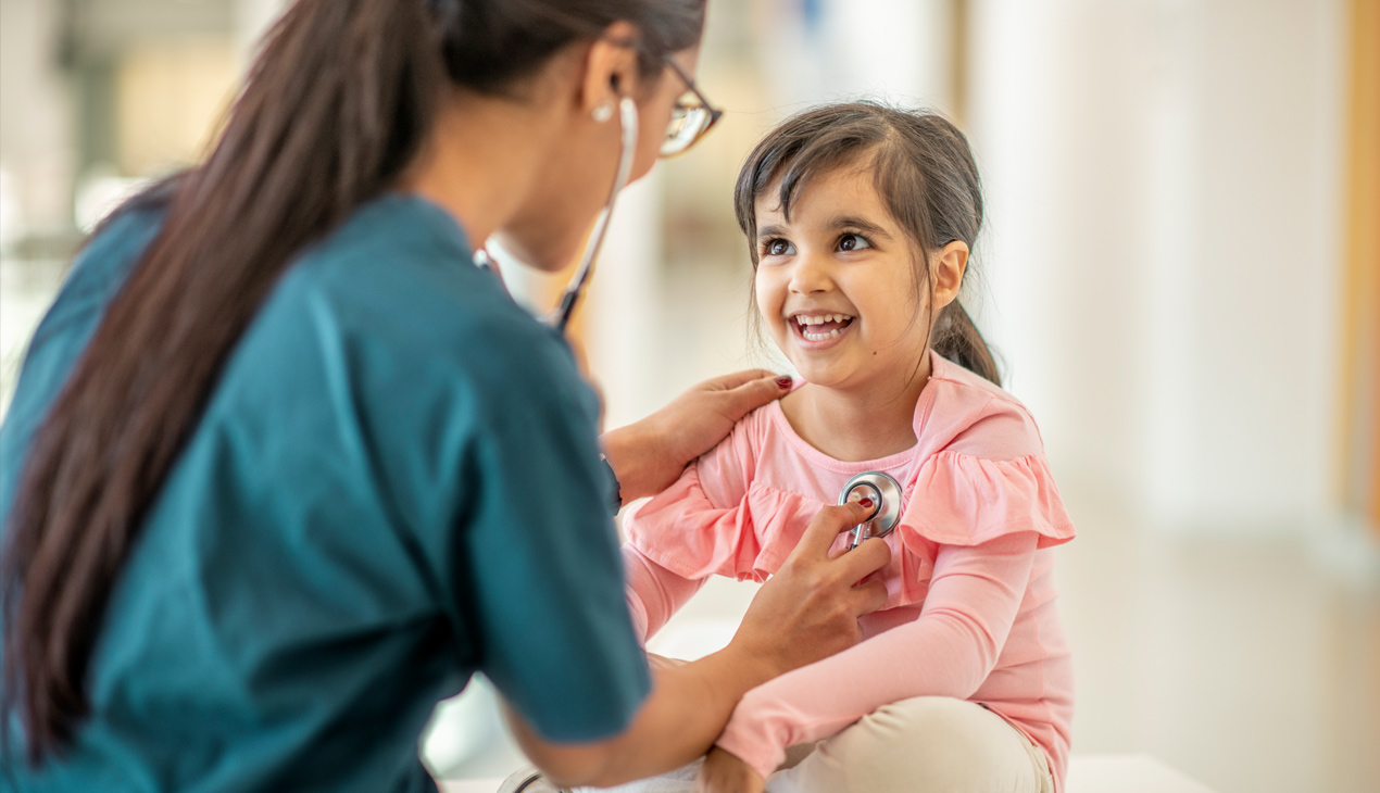 Pediatrician and child smiling
