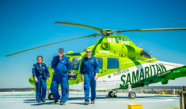 Three EMTs with the helicopter