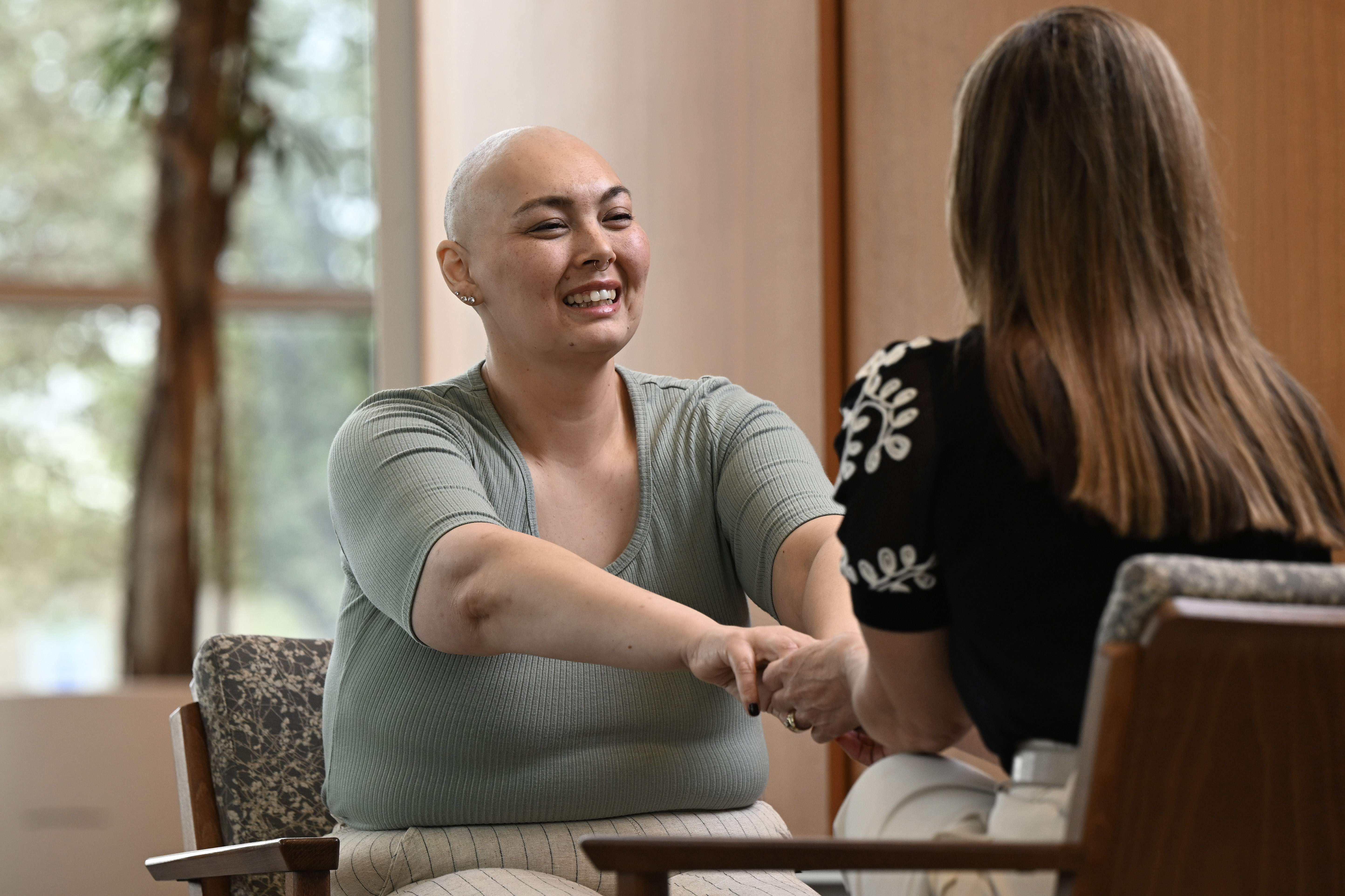 Patient smiling and holding hands
